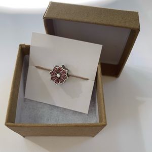 Pandora 2016 Black Friday “Poinsettia” sterling charm in a kraft gift box